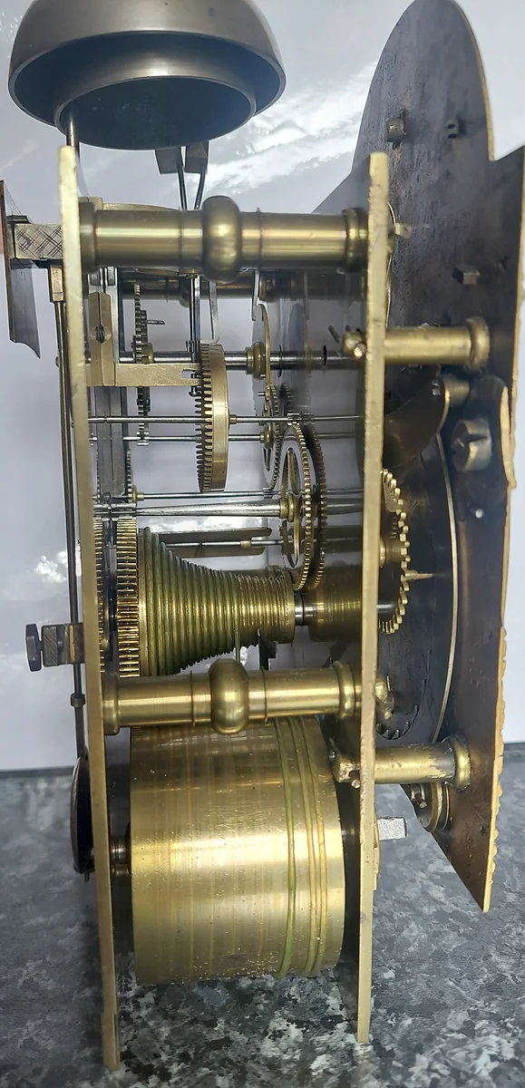 A fusee movement out of its case, seen from the side, with its bell above