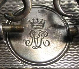 Engraved monogram and coronet on the top of a small silver carriage clock