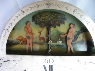 The dial arch after restoration, with the new figures and the serpent coiled around the tree