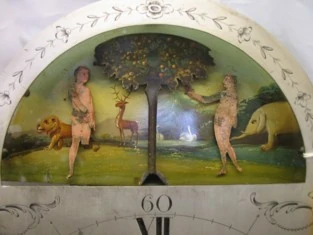 The dial arch before restoration, with the original Adam and Eve